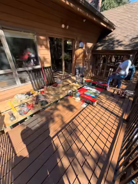 Crew installing steel railing on a composite deck